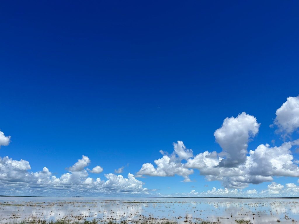 Cloud reflections on the flooded white salt pan, Namibia